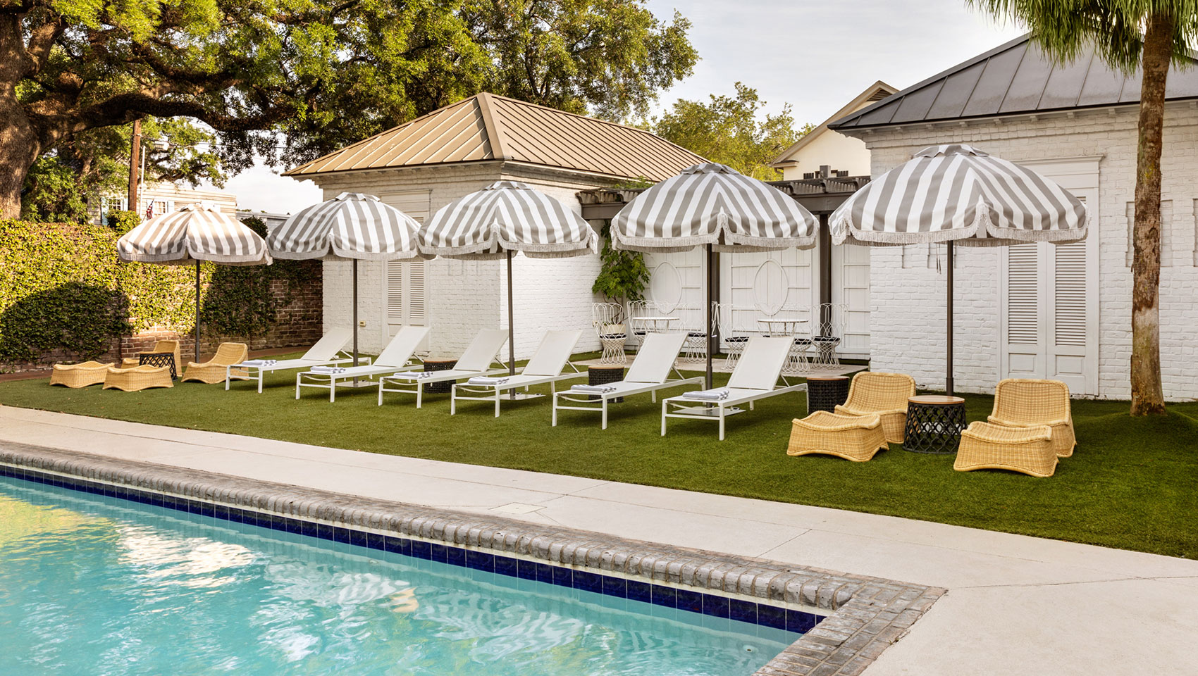 The Kimpton Brice Hotel pool with lounge chairs and umbrellas