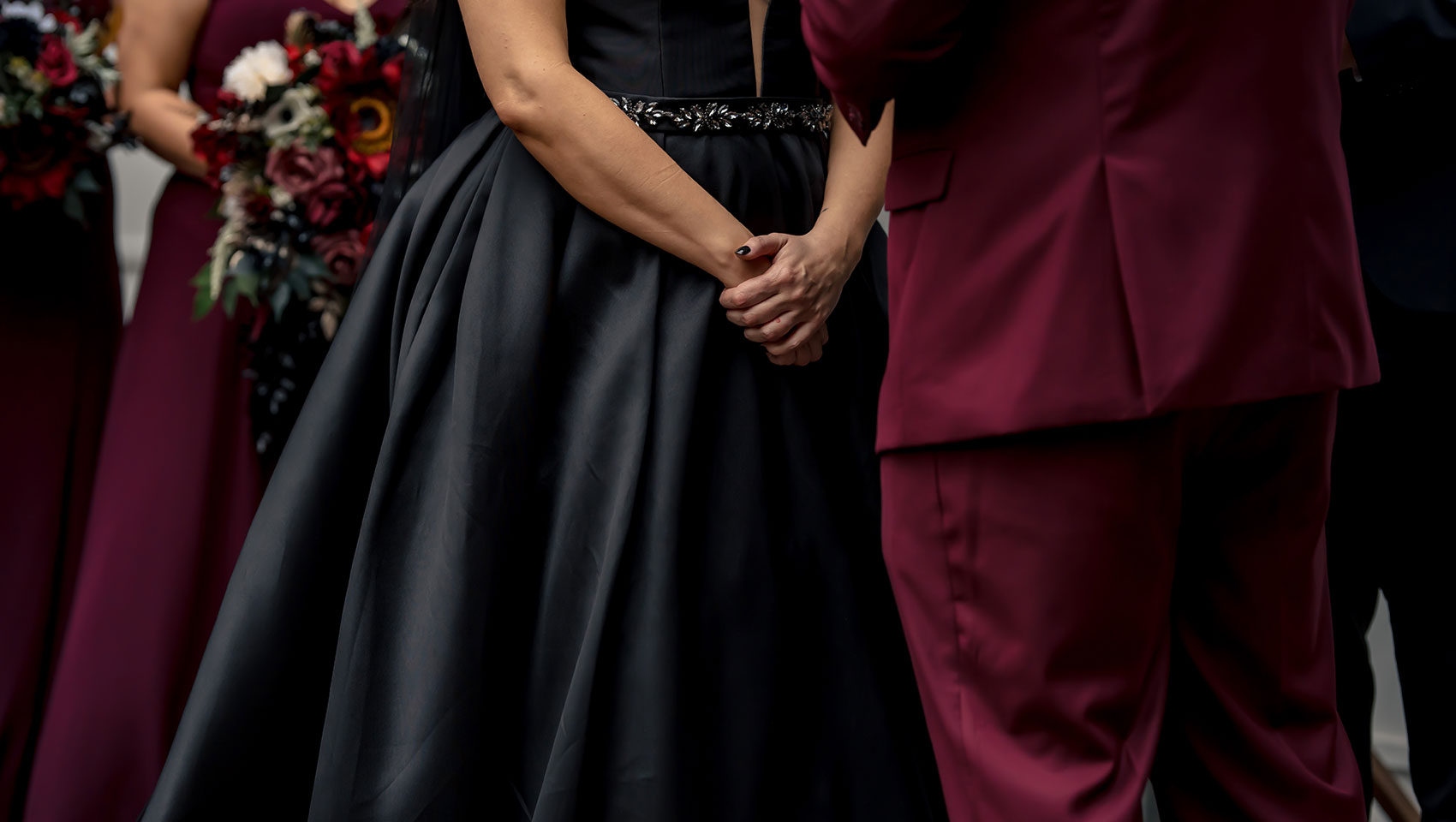 Bride and groom hold hands